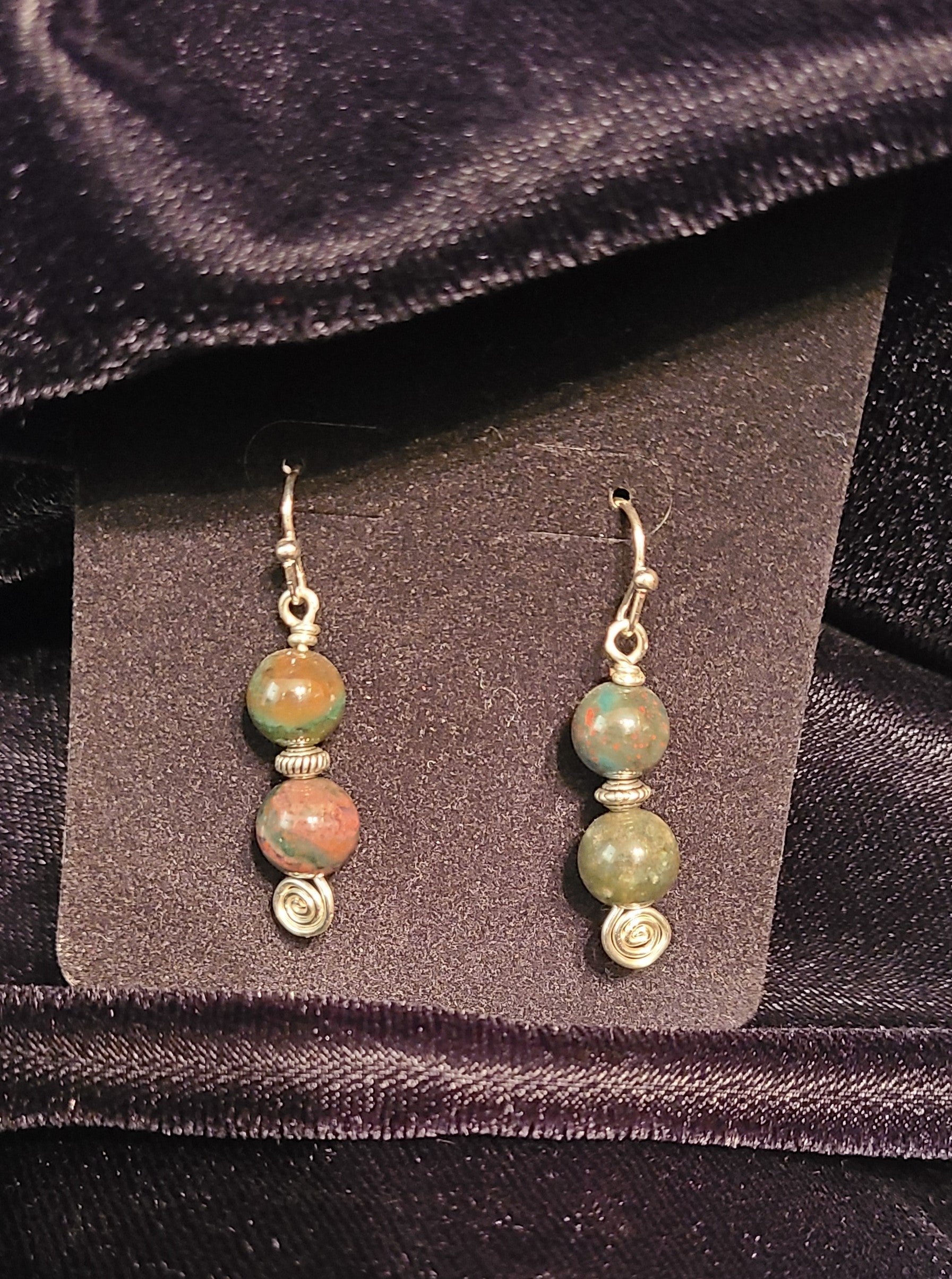 Bloodstone jasper earrings atop silver spiral